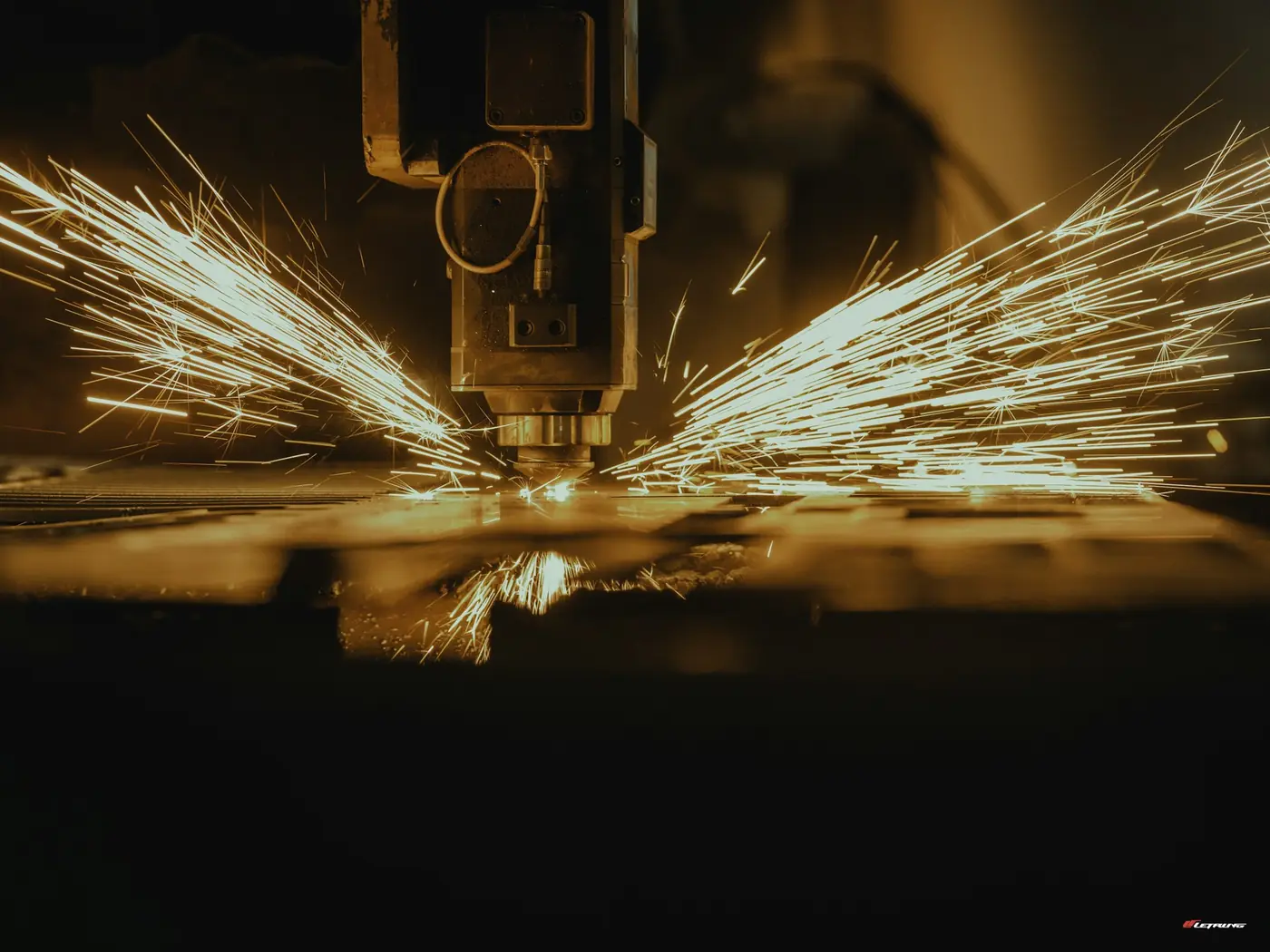 Sparks from a machine cutting sheet metal